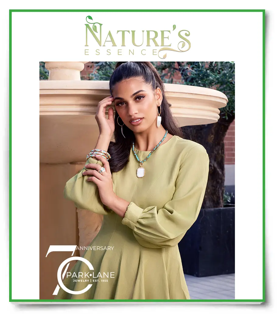 Model in a green dress, wearing light gold and aqua colored, summer jewelry
